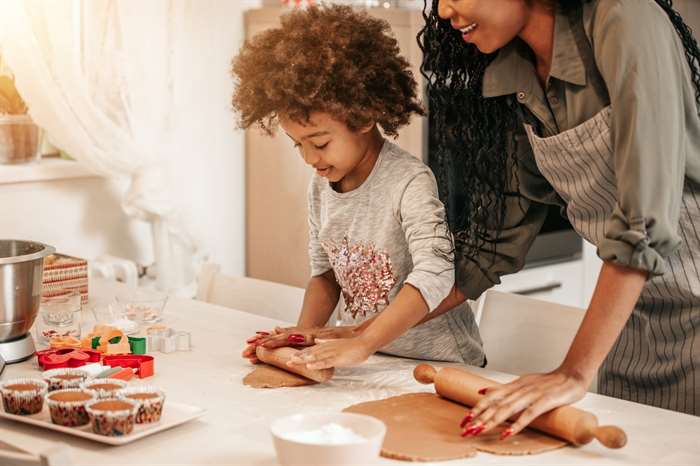 Girl Making Gingerbread Cookies With Mom