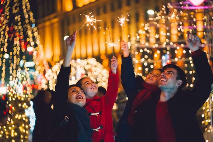 Young family with two kids celebrating Christmas.