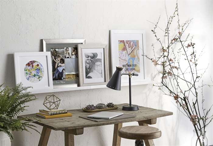 farmhouse office design with wooden desk and framed rustic wooden pictures