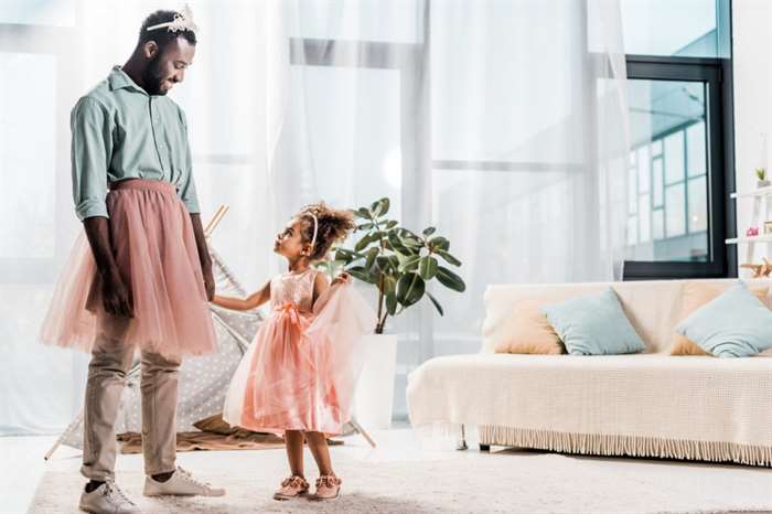 father looking at cute daughter in beautiful dress