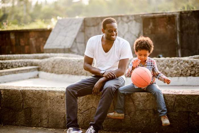 A father and son play basketball for Father's Day