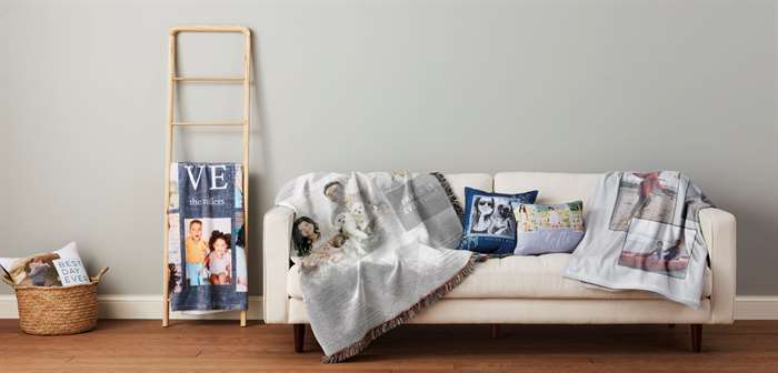 Personalized blankets with pictures and pillows displayed on a couch