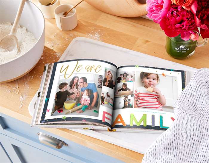 A family photo book with the caption We Are Family.