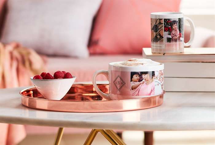 Mug and bowl of berries on table.