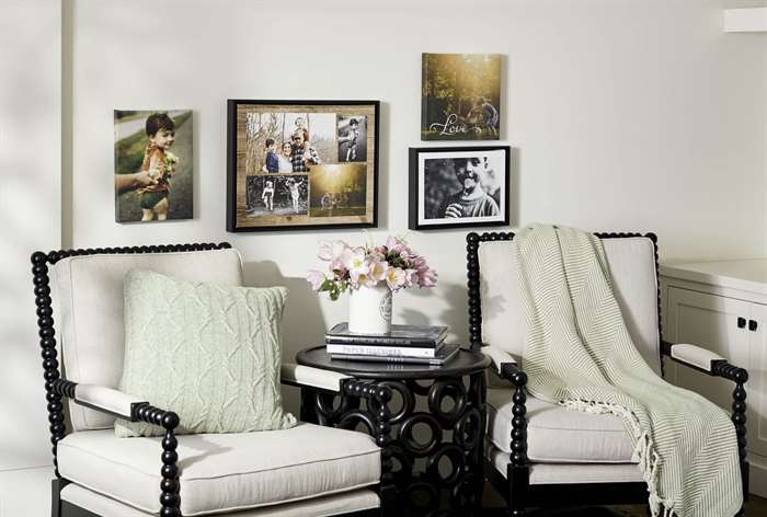 Framed prints hanging over chairs.