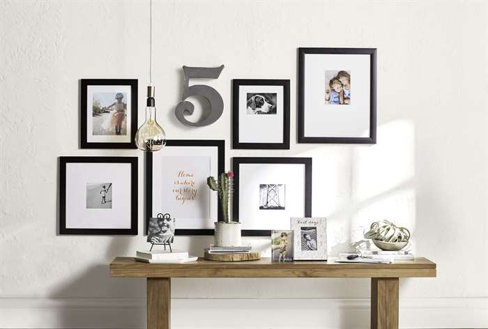 Framed gallery wall over entryway table.