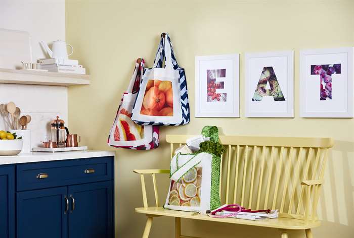 Canvas prints hanging over bench in kitchen.