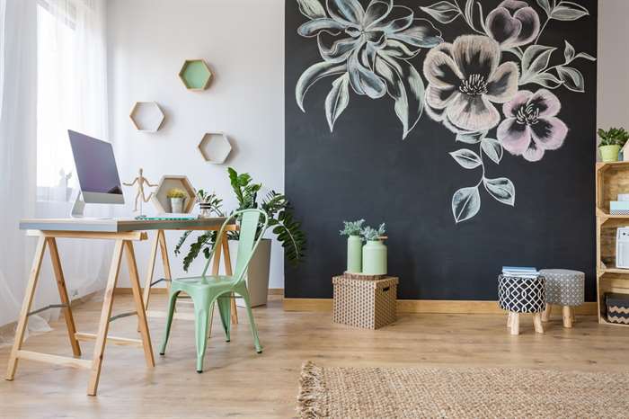 Spacious room with desk, chair and decorative chalkboard wall