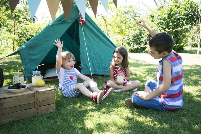 Three little friends having backyard birthday party.