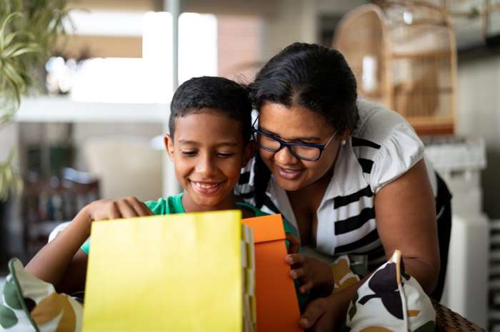 Mother and son embracing and receiving gifts.