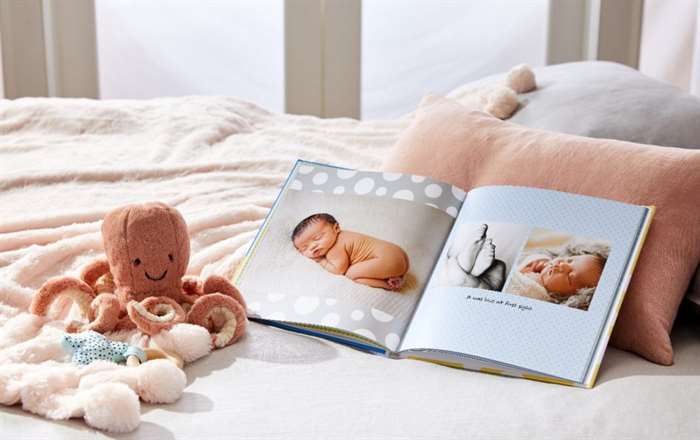 high quality baby photo book with custom photos on bed