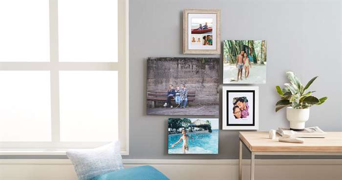 Small gallery wall with different sizes of photo prints with and without picture frames