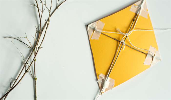 Yellow kite made out of twigs