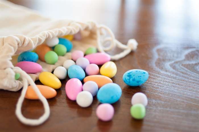 Trên bàn gỗ một túi kẹo kỳ lân đầy màu sắc