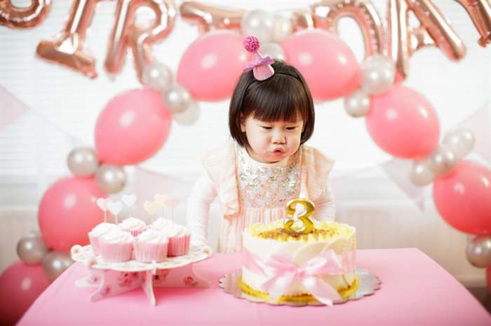 toddler girl celebrating her third birthday at a party hall