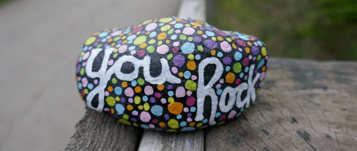 Kindness rock with painted you rock message and colorful polka dots