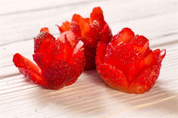 Three red heart flowers from strawberry for valentines day