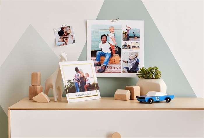 Family pictures hanging in baby nursery.