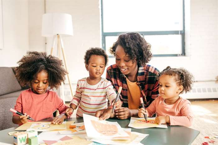 Toddlers creating with paper and markers