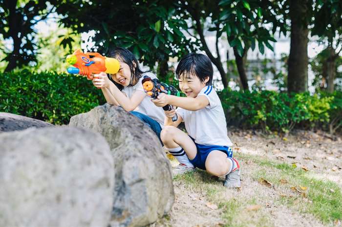 kids playing outside with water guns