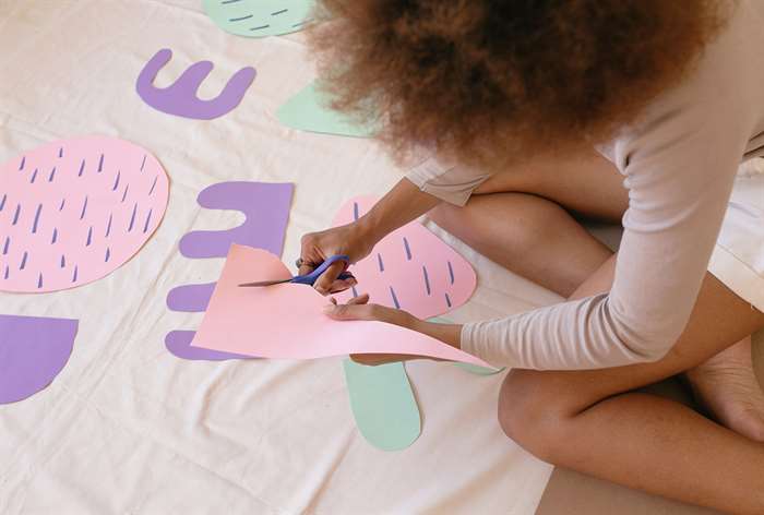 Woman cutting out paper.