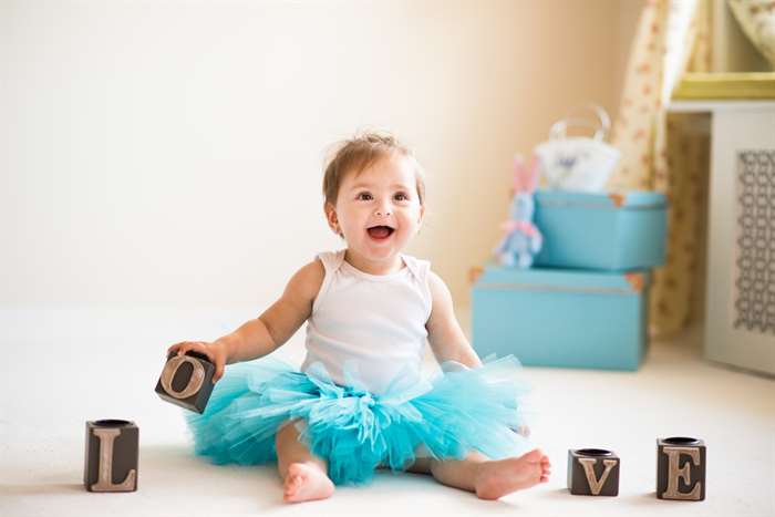 One year old girl, portraits in studio interior.