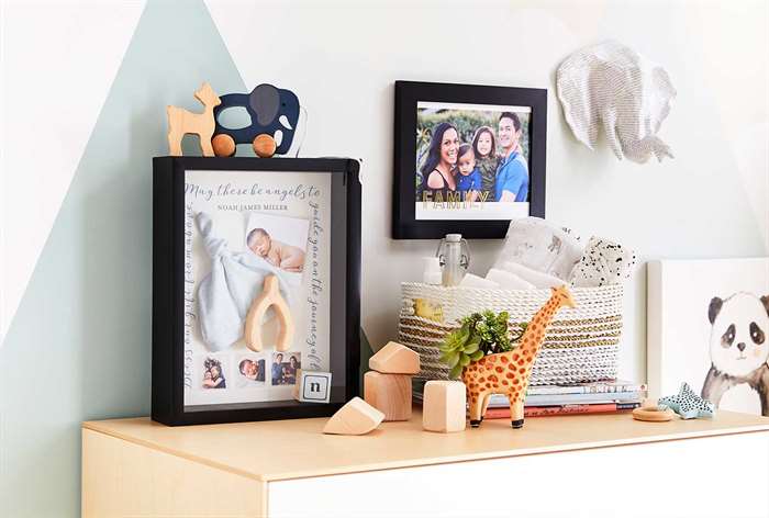 Framed pictures in baby room.