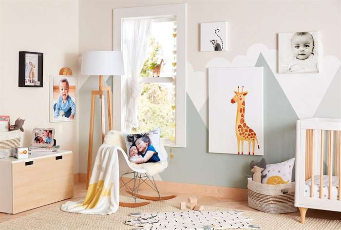 Nursery room with canvas portraits on wall.