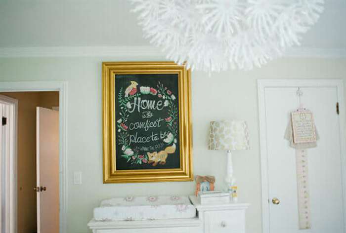 Framed chalkboard in baby nursery.