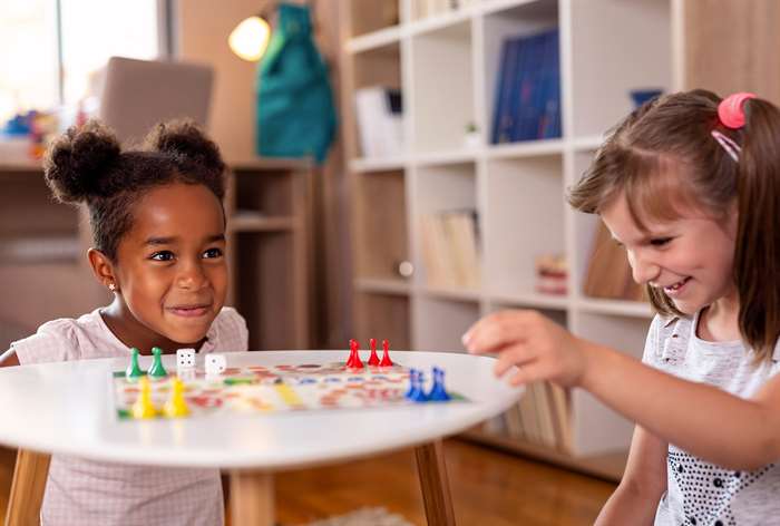 Two kids playing board game.