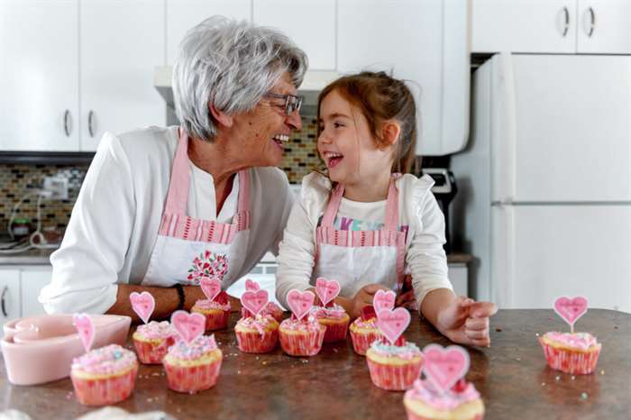 grandma and granddaughter making valentine's day sweets together