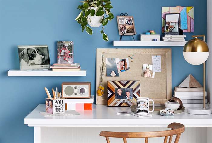 Corner desk decorated with pictures.