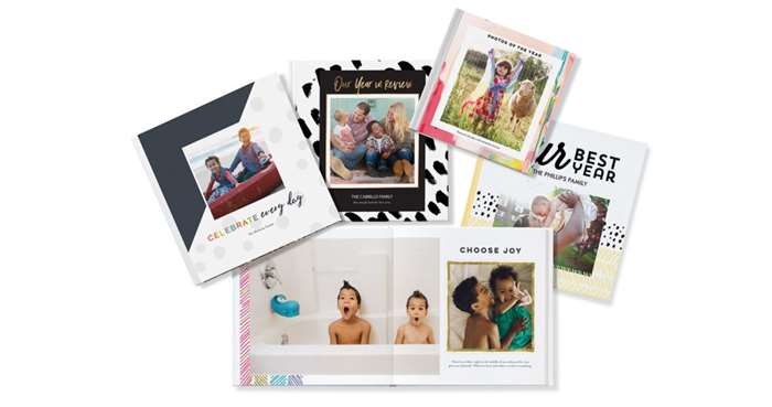 Variety of year in review photo books with photos of family and kids