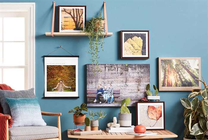 Photo gallery wall on blue wall with home decor