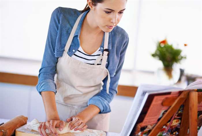 Woman looking at cookbook. 