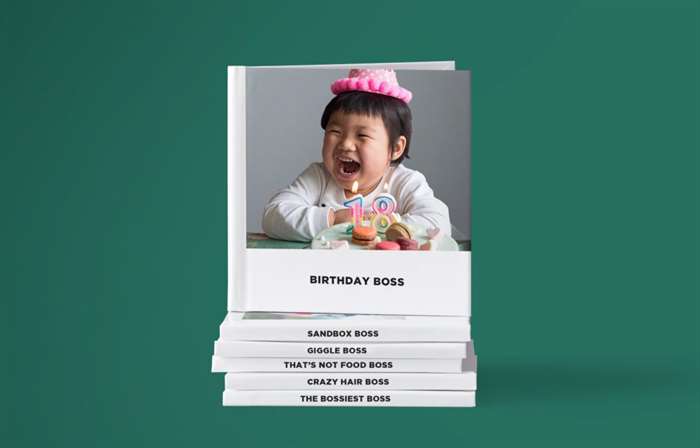 A stack of 6x6 instant photo books with a baby on the cover