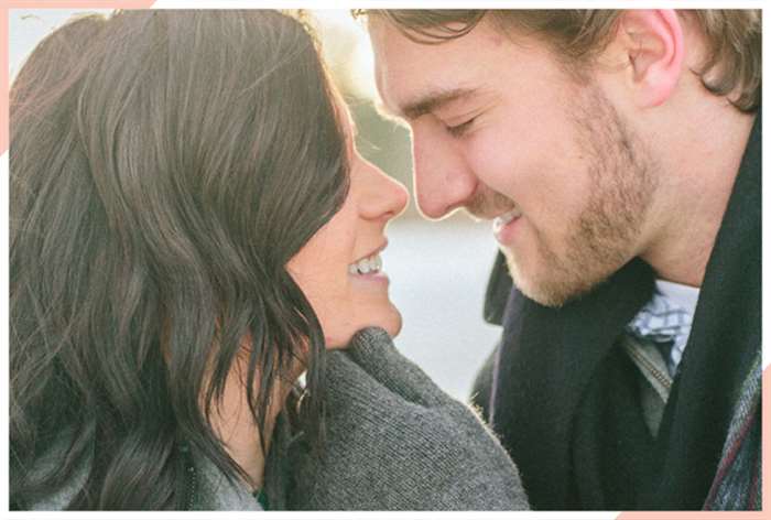 couple holding chin christmas engagement photo