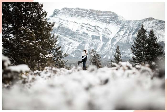 engaged by mountain christmas engagement photo