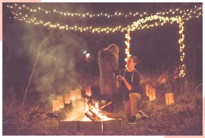 engaged by a fire christmas engagement photo