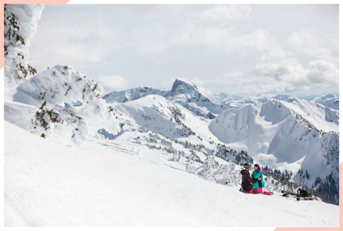 engaged on snowy mountain christmas engagement photo