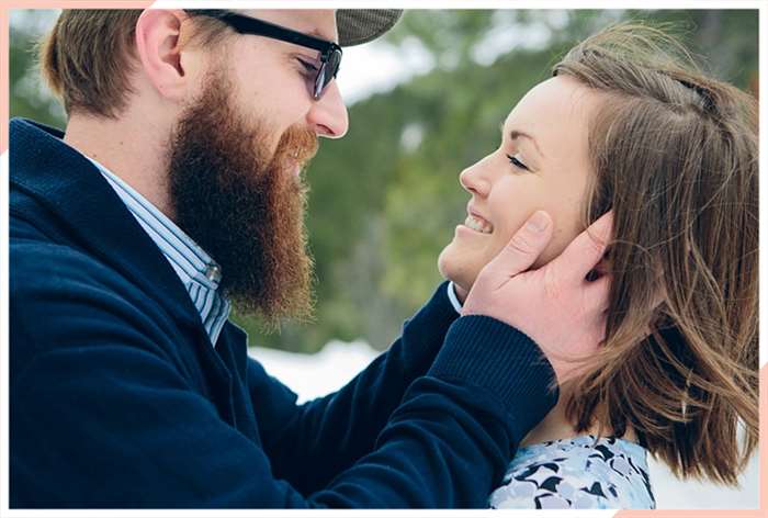 man cradling ladies face christmas engagement photo