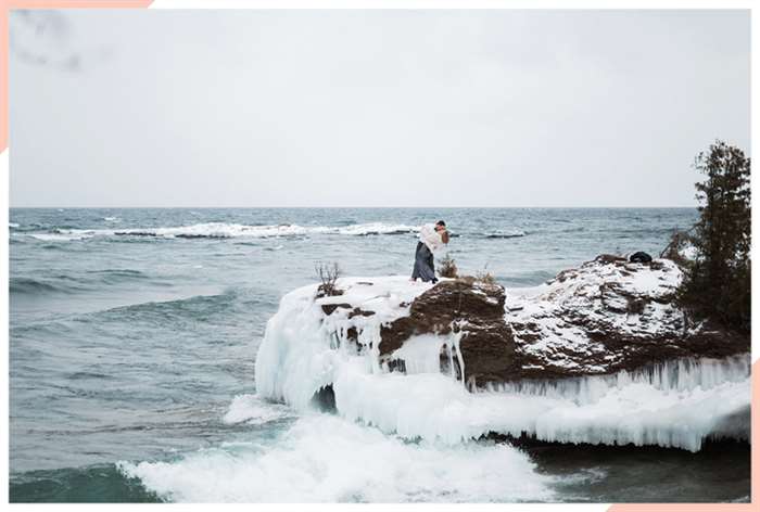 kiss icy ocean christmas engagement photo