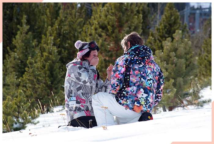 snowboarder couple getting engaged christmas engagement photo