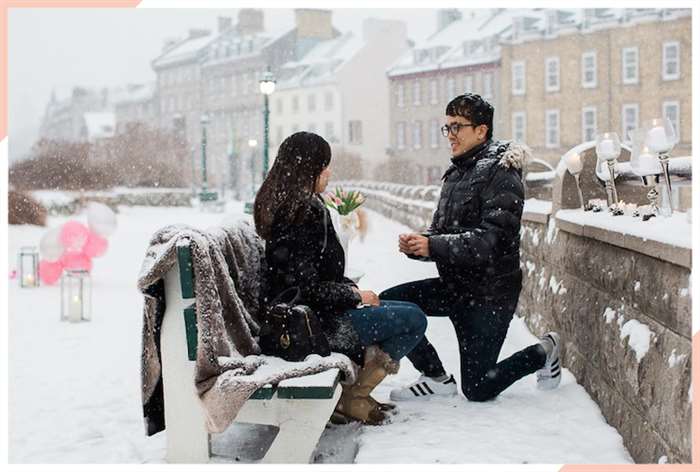 engaged in europe on a bench christmas engagement photo