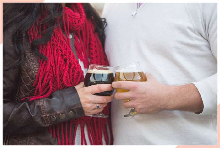 couple toasting glasses christmas engagement photo