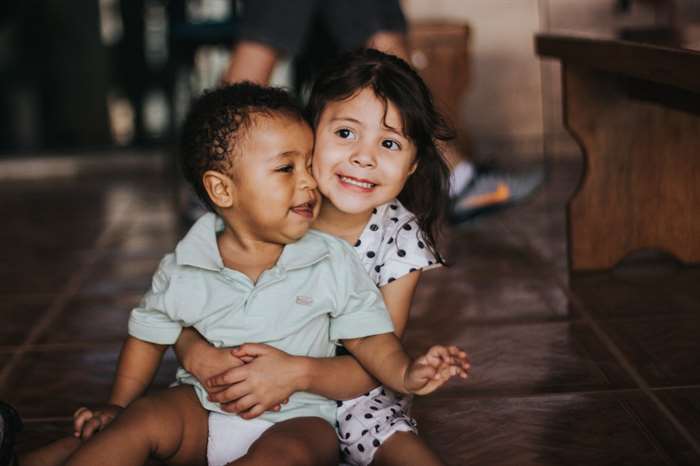 brother and sister hugging