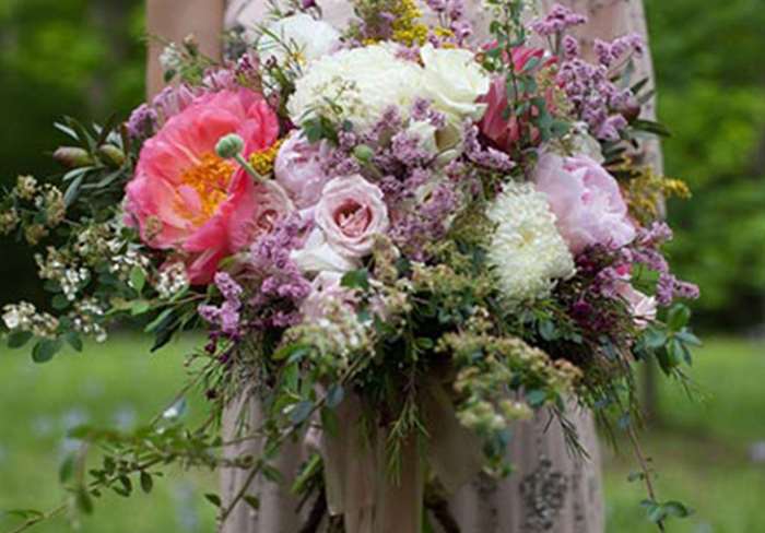 Wild flower wedding bouquet with purple flowers.