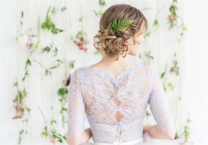 Bride in her wedding dress with a lavender lace back.