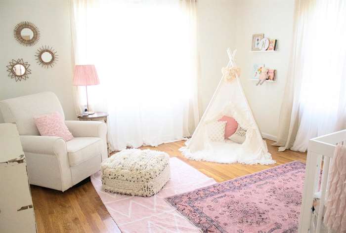 Baby girl room with pink rugs.