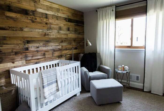 Rustic wood wall in baby nursery.